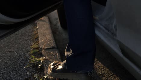 car door with feet getting into car medium shot