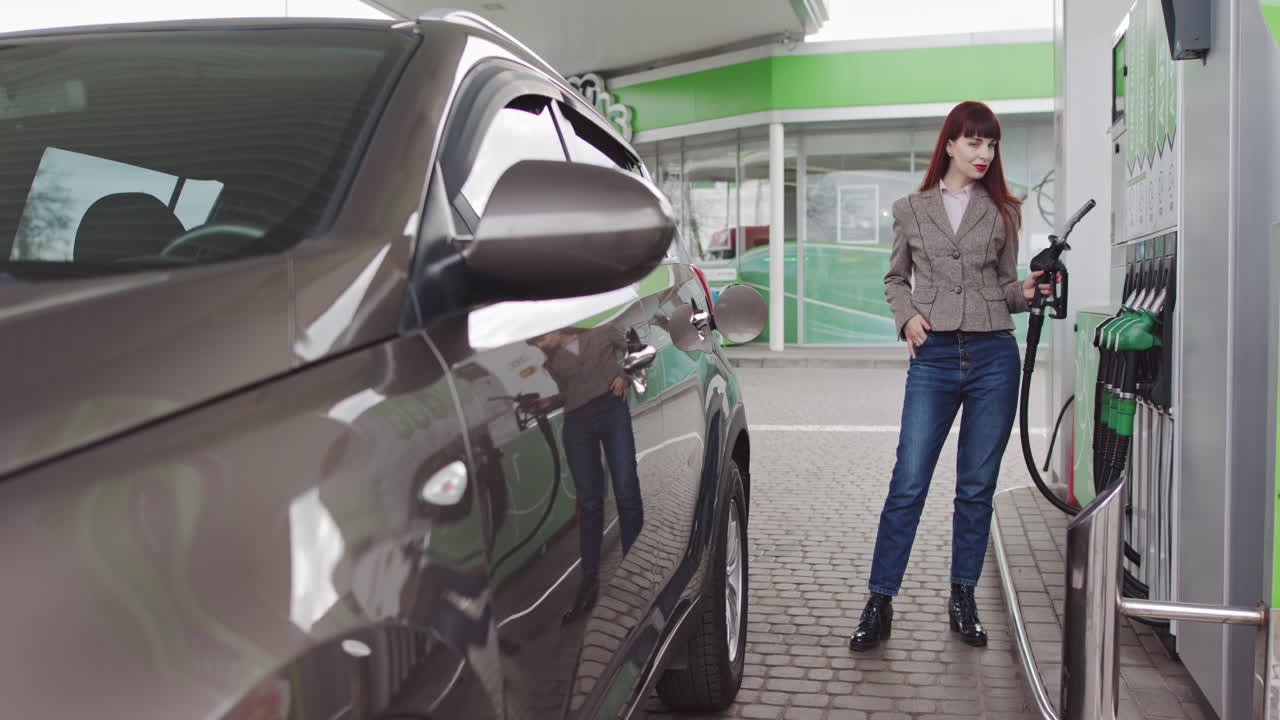 Woman Filling Up Her Car at a Gas Station