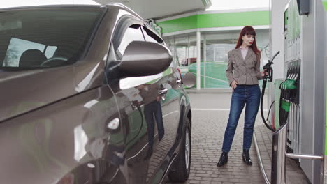 woman filling up her car at a gas station