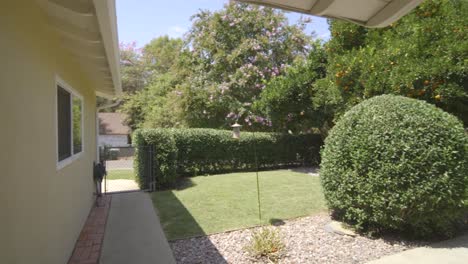 Entrance-of-a-house-with-the-trees-and-plants-in-the-lawn-garden