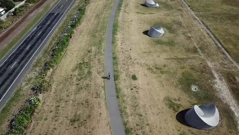 Aerial-shot,-tracking-on-a-person-cycling-on-the-bike-track-in-napier,-new-zealand