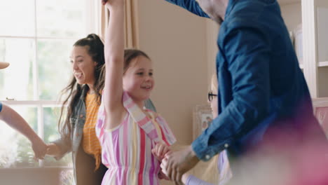 happy multiracial family dancing at home having fun enjoying dance celebrating exciting weekend together