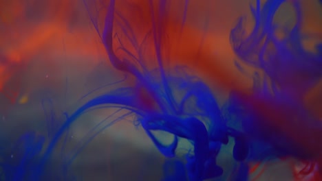 acrylic paints are poured into water