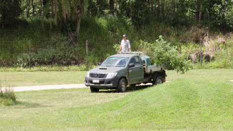 man feeds giraffe from truck in wildlife park