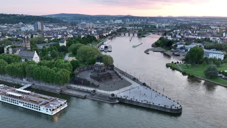 Aerial-drone-view-of-the-deutsche-Eck,-monument-in-the-city-of-Koblenz,-Germany-at-sunset