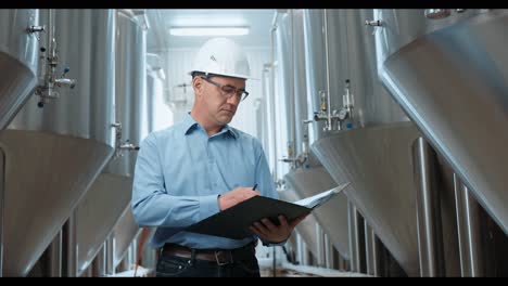 engineer inspecting brewery equipment