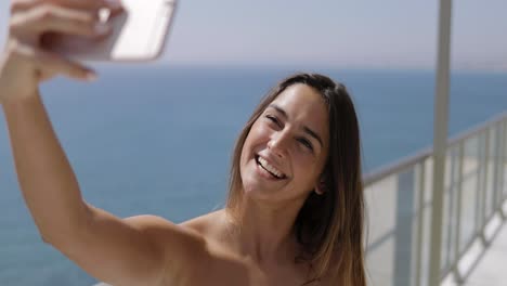 charming woman posing for selfie in hotel