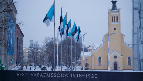 six estonian flags flying near war of independence victory column near freedom square, tallinn with st