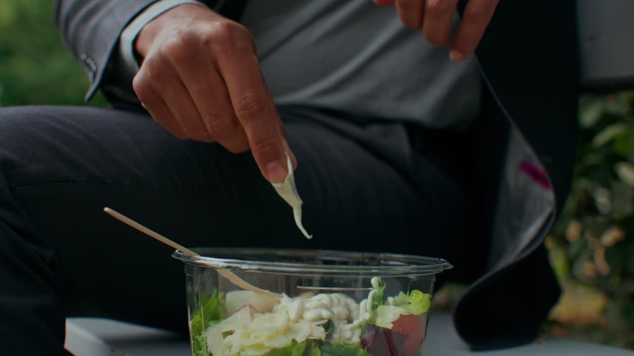 Adding dressing to a salad