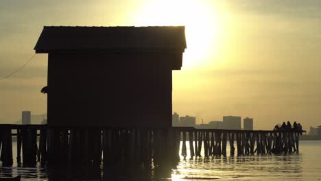 silhouette wooden bridge at penang clan jetty