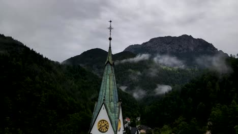 Slovenia-Small-Town-Surrounded-By-Misty-Pine-Forest-Mountains-Aerial-Drone-6