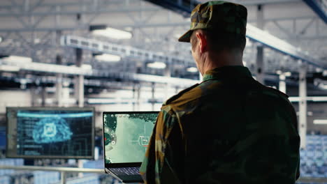 military data center specialist using radar software on laptop