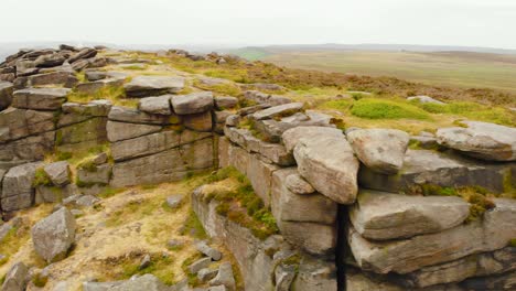 Aerial-close-up-view-across-rocky-Stanage-edge-untouched-Peak-district-gritstone-escarpment-terrain