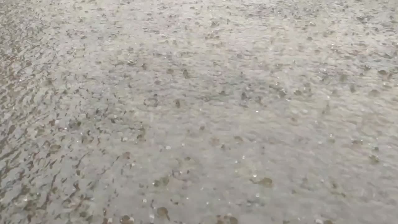 Falling rain drops in the water, slow motion footage, rainfall view