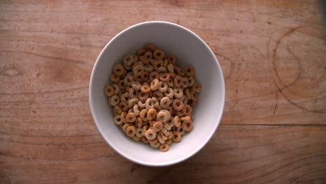 point of view shot of pouring breakfast cereal into bowl