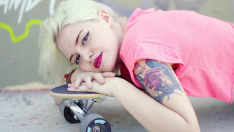 pretty young blond woman with an arm tattoo