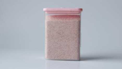 pink himalayan salt in a pink container