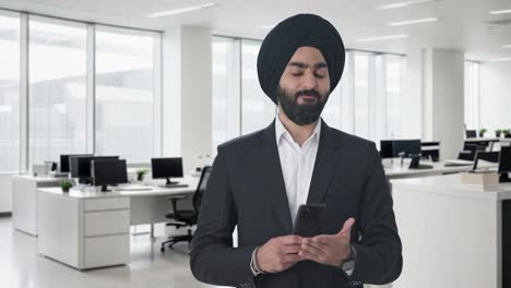 angry sikh indian businessman texting someone