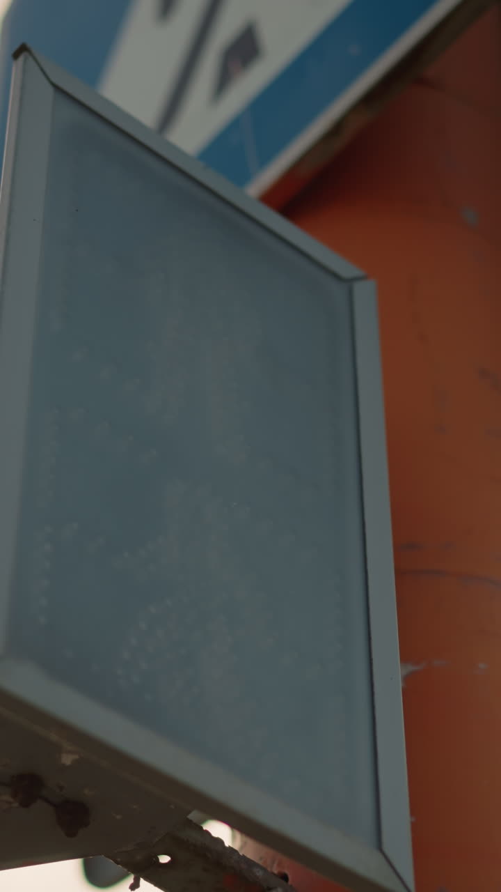 green to red pedestrian signal transition showing countdown and stop icon, LED pixels change state as intersection cycles, urban tension and safety pause for commuters and drivers