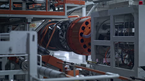 tire manufacturing machine rotating with rubber tape in technological workshop