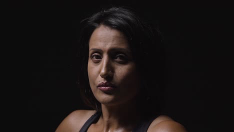 studio portrait of mature woman wearing gym fitness clothing ready to exercise