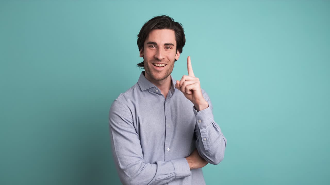 Thoughtful man with great idea in blue studio
