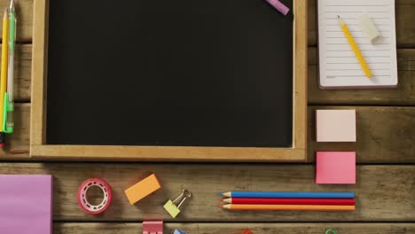 video of blackboard with copy space and school items on wooden background