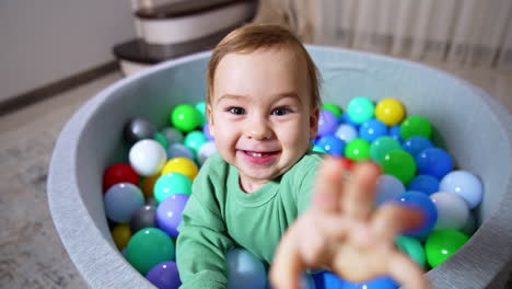 baby playing in a ball pit
