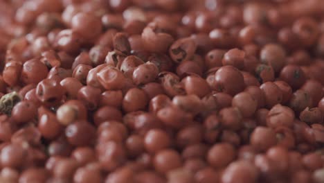 full of red pepper corn falling down in close up shot