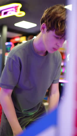 teenager playing arcade games