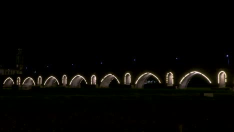 night view of the beautifully illuminated roman bridge of ponte de lima.