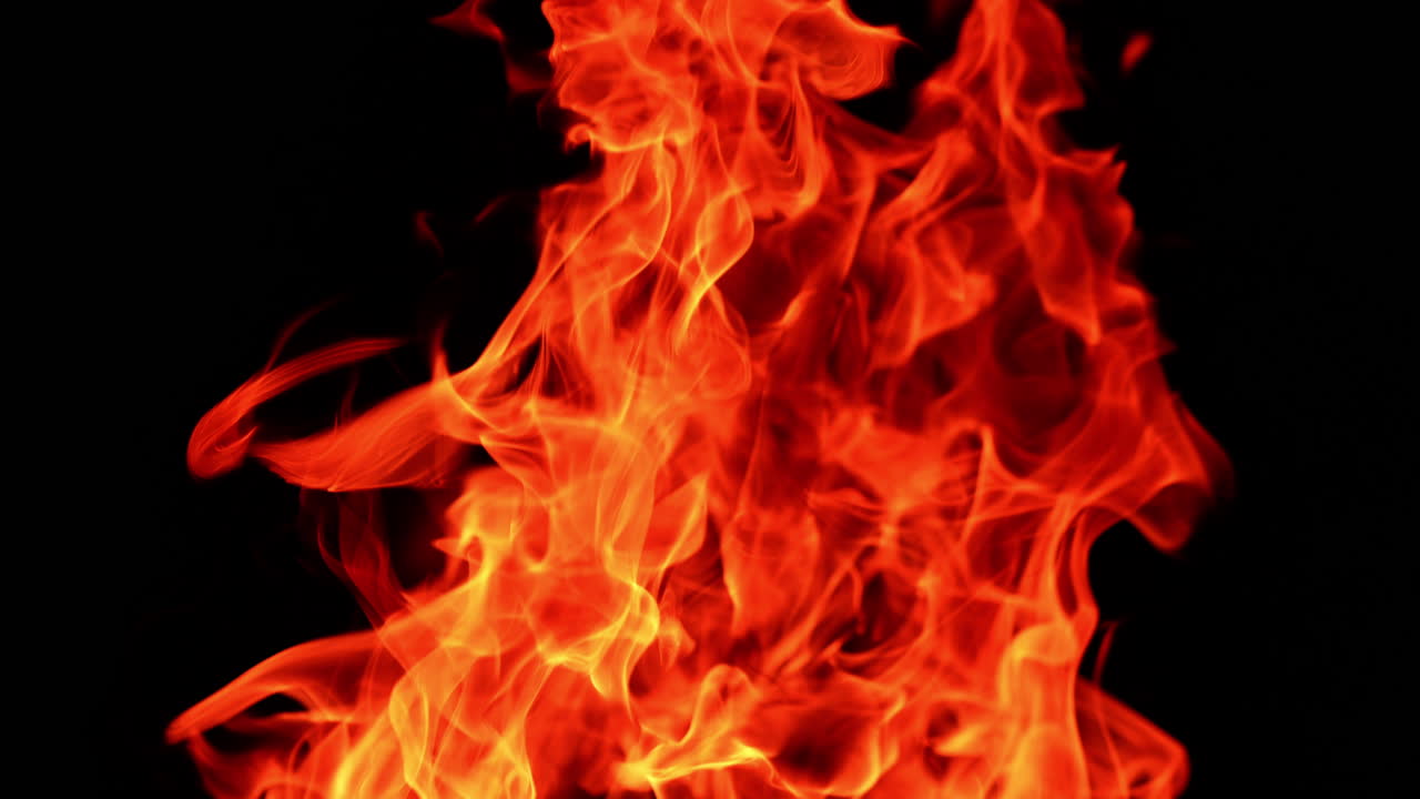 Hot dangerous fire burning. Fast moving red flames isolated at black backdrop. Close up.