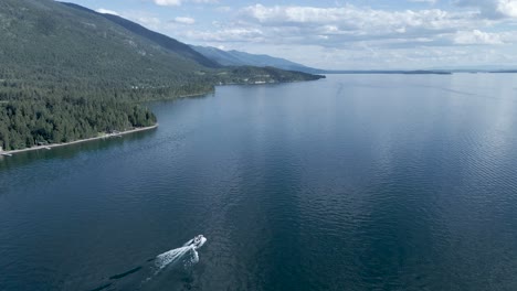 fresh water lake with boaters enjoying summer day in kalispell, montana - aerial drone