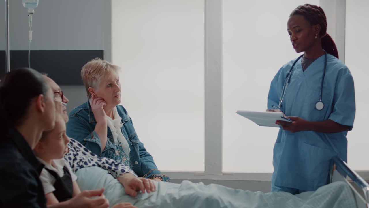 African american assistant explaining medication to old man and visitors