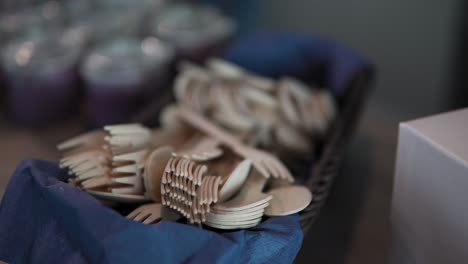 wooden cutlery forks knives and spoons are placed on the buffet table