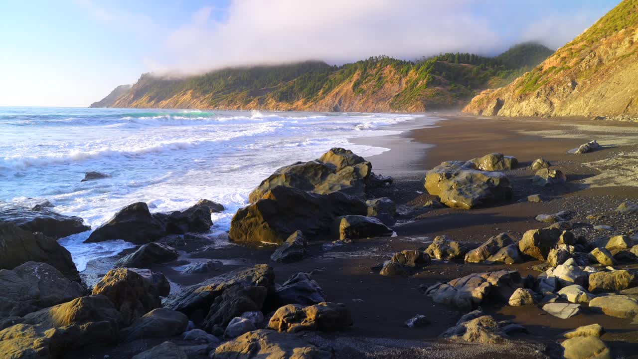 USAL Beach Campground sunset Pacific Ocean surf waves rocky black sand Lost Coast Trail California evening mist fog on bluffs rugged coastline remote untouched Sinkhole Wilderness nature landscape pan