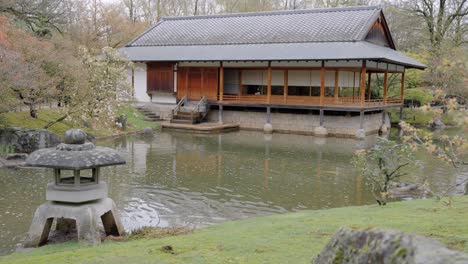 ceremony house sits by a tranquil pond in the japanese garden in hasselt, belgium - wide static shot