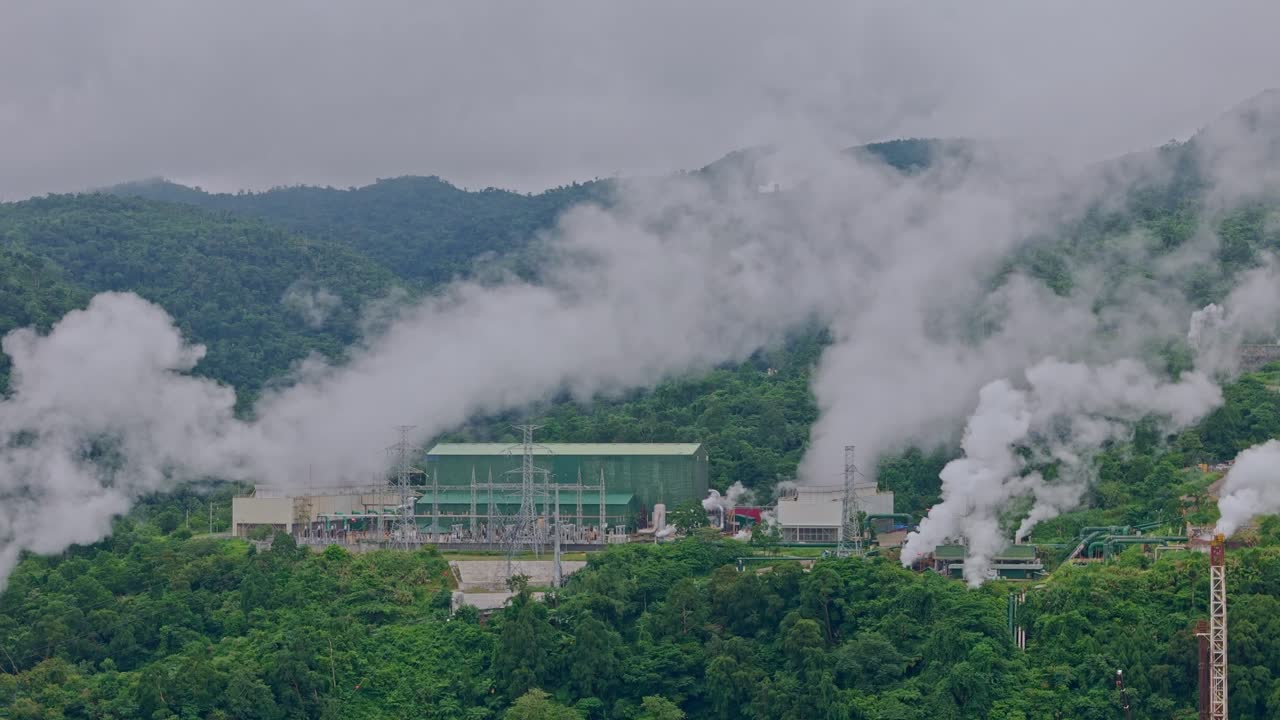 Geothermal plants emitting steam amidst forests in volcanic mountains above Ormoc, Leyte