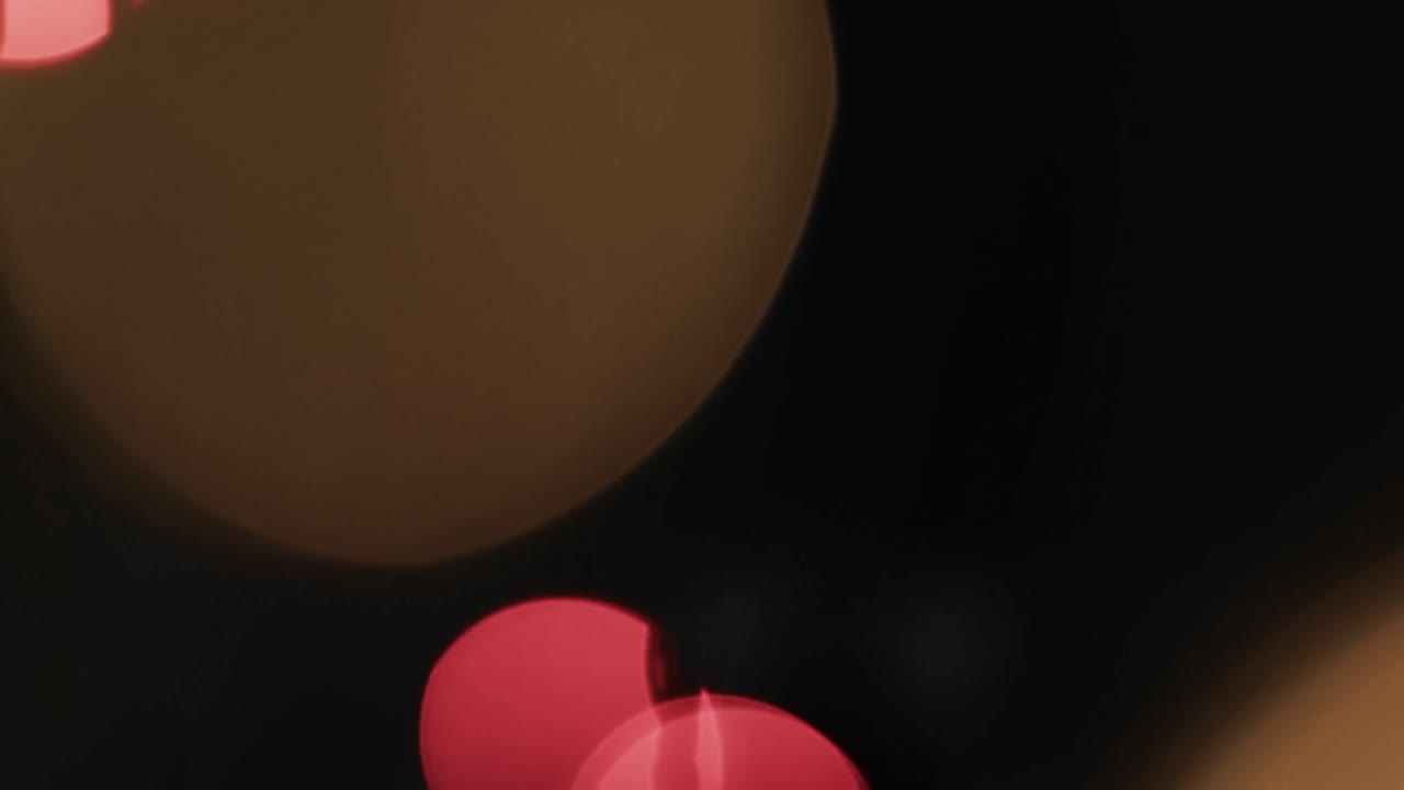 Video of flickering multi coloured bokeh spots of light with copy space