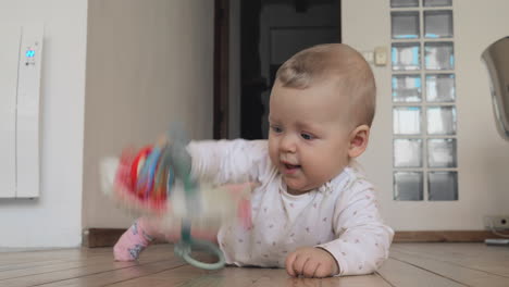 niña jugando en un piso de madera