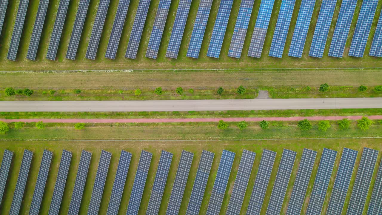 Solar panels across green fields captured aerially