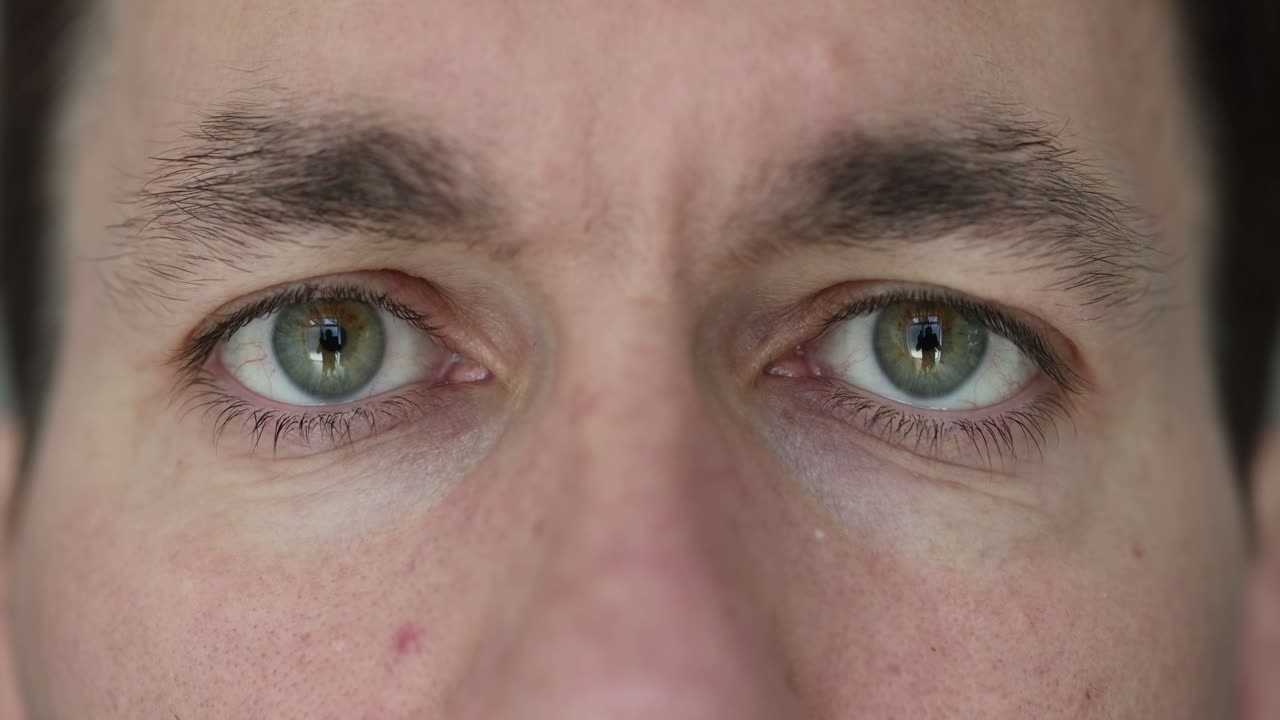 Close-up of a Man's Green Eyes Blinking
