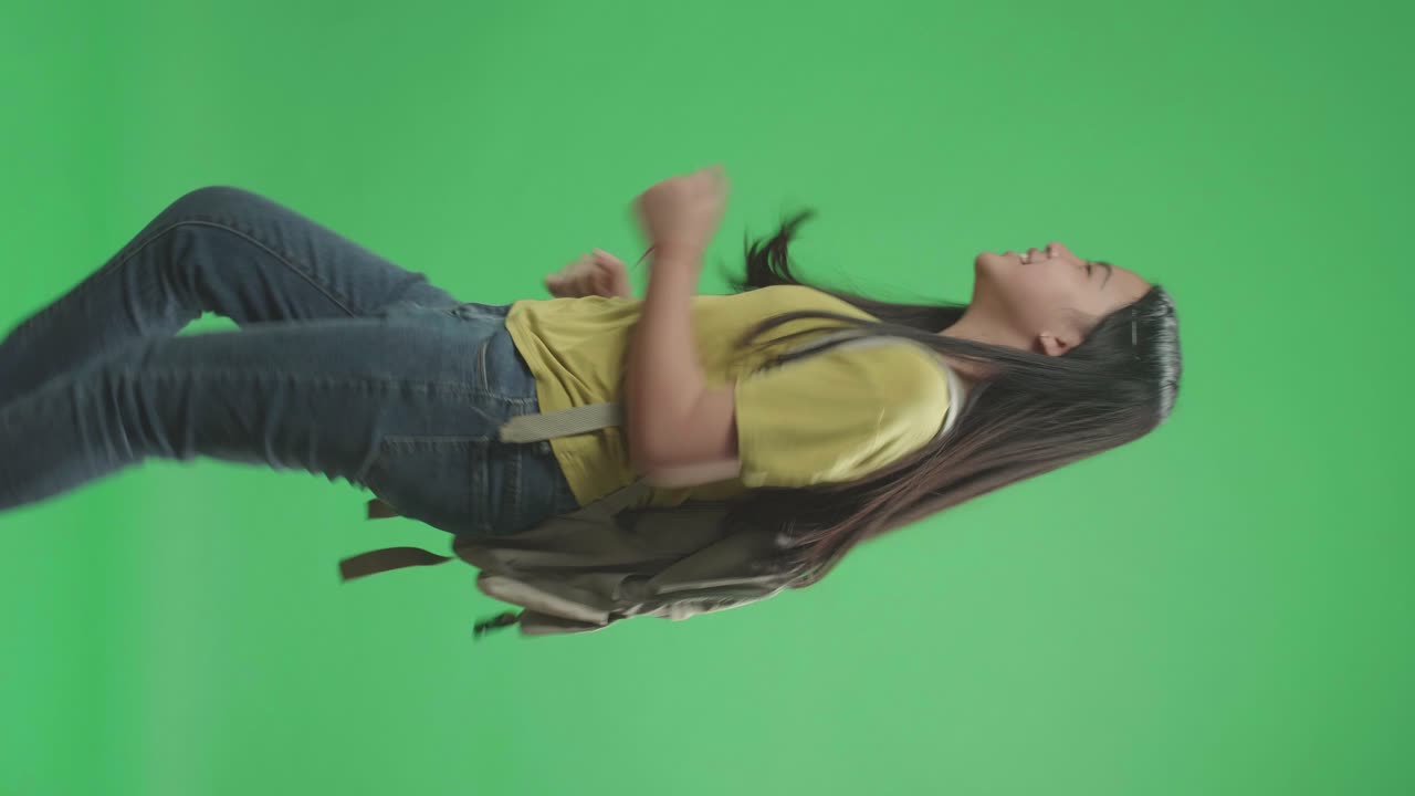 Side View Of Asian Girl Student Running To School On Green Screen Chroma Key