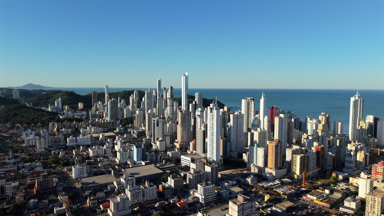 Establishing Aerial drone fly Camboriu Santa Catarina city in Brazil, Skyscraper buildings over the sea and daylight skyline