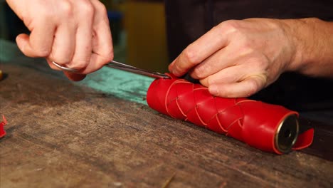 artisan crafting red leather product