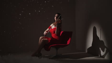 woman playing violin in red dress