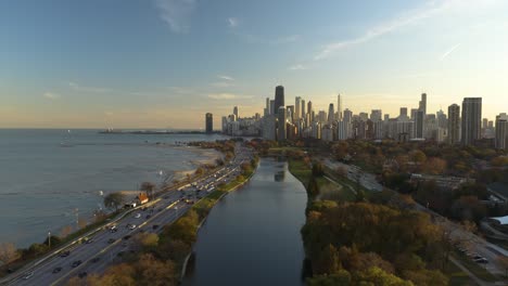 beautiful establishing shot - drone flying towards chicago during autumn sunset