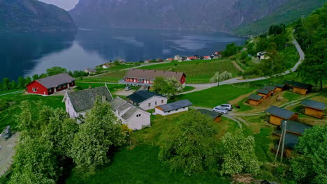 aurland village in norway on the banks of a picturesque fjord - aerial flyover