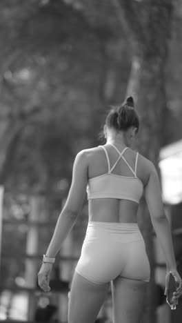 happy young woman in athletic wear celebrating outdoors