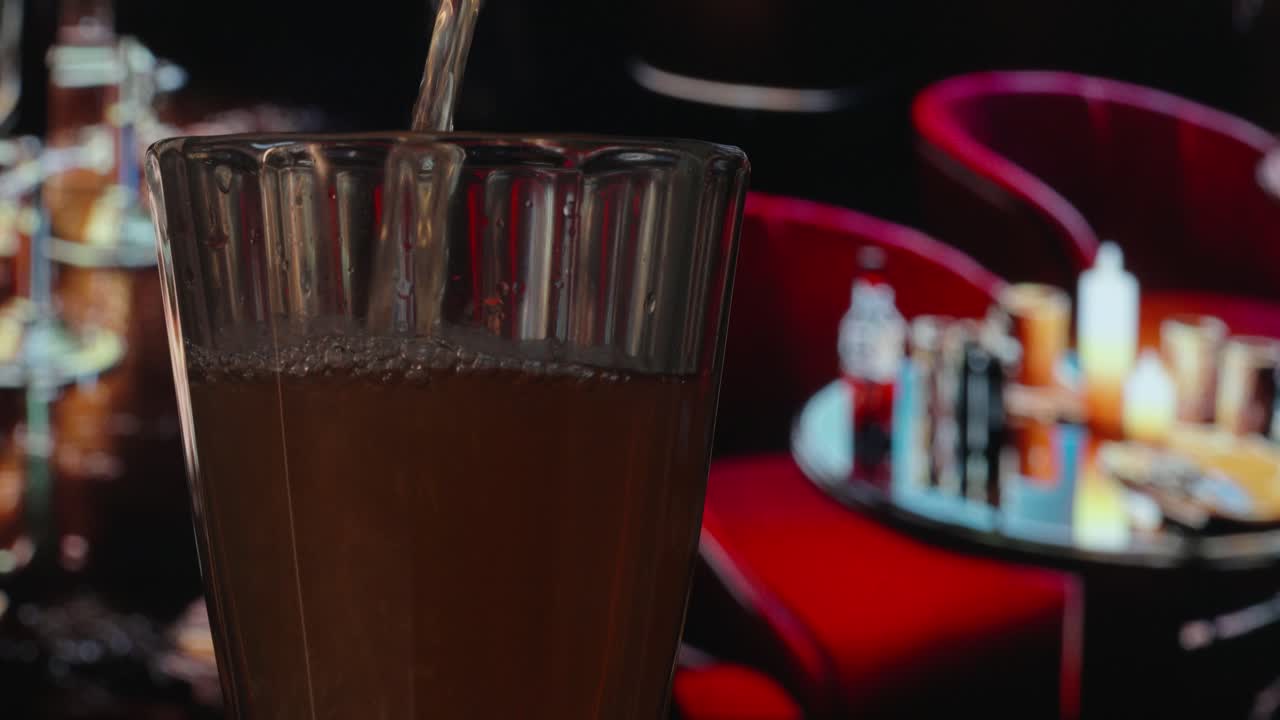 a glass is poured in a bar close up